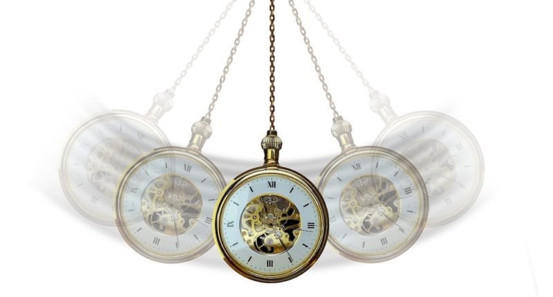 Intuitive eating mistakes: Photo of a stopwatch on a chain swinging back and forth like a pendulum