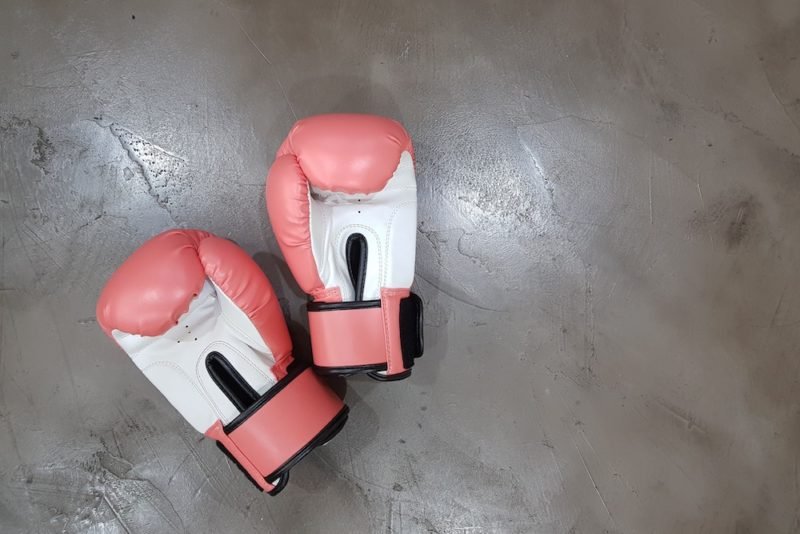 Nutrition myth busting: Photo of pink and white boxing gloves against a polished concrete background.