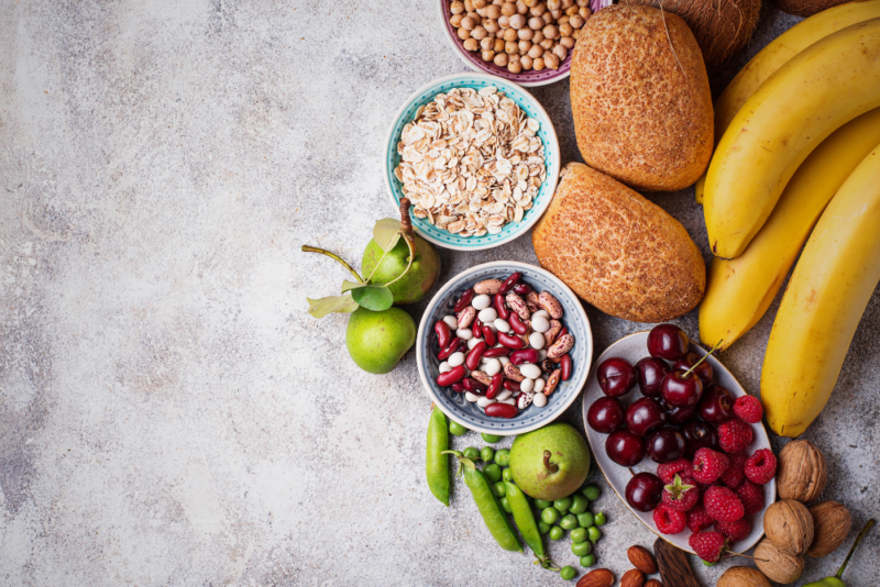 Photo of foods that are high in FODMAPs, including wheat bread, chickpeas, beans, pears, cherries, raspberries, peas and walnuts.