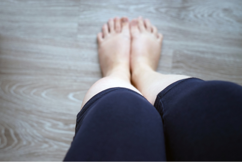 A woman reflecting on her body, representing the hidden struggles of atypical anorexia and eating disorders in larger bodies.