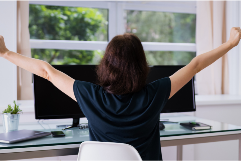 A woman doing a quick yoga stretch during a workday, practicing intuitive movement and exercise snacking
