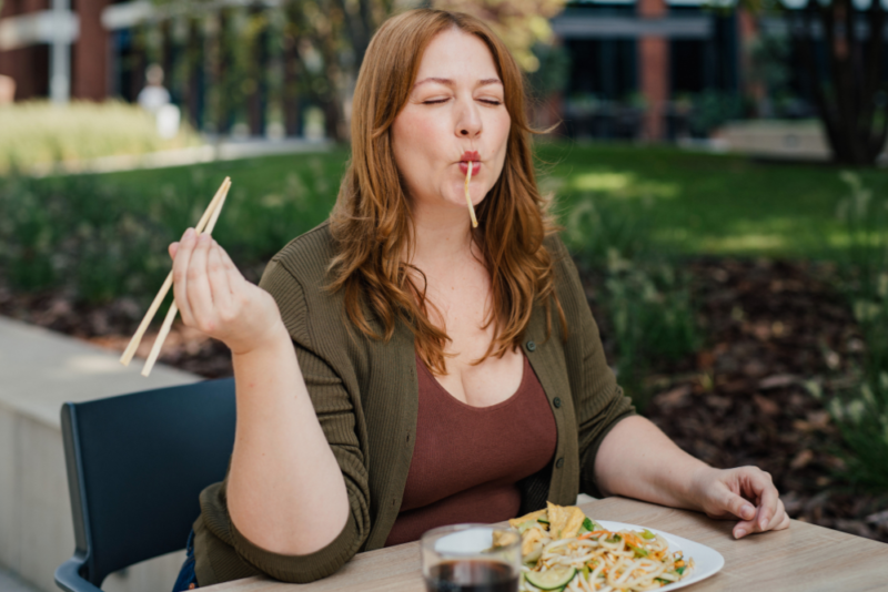 woman enjoying a plate of pasta